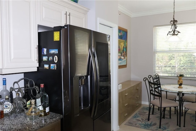 kitchen with ornamental molding, a wealth of natural light, white cabinets, and black refrigerator with ice dispenser