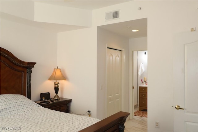 bedroom featuring marble finish floor and visible vents