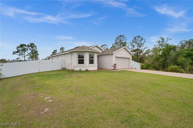 ranch-style home with a garage, fence, concrete driveway, stucco siding, and a front yard