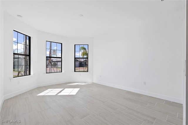 spare room featuring baseboards