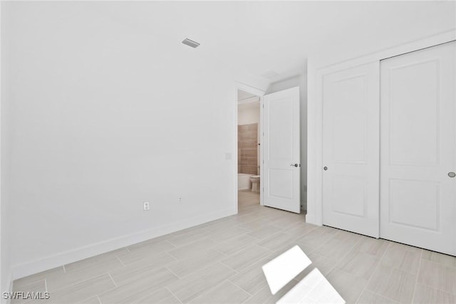 unfurnished bedroom featuring a closet, visible vents, and baseboards