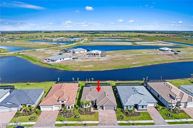 birds eye view of property featuring a water view and a residential view