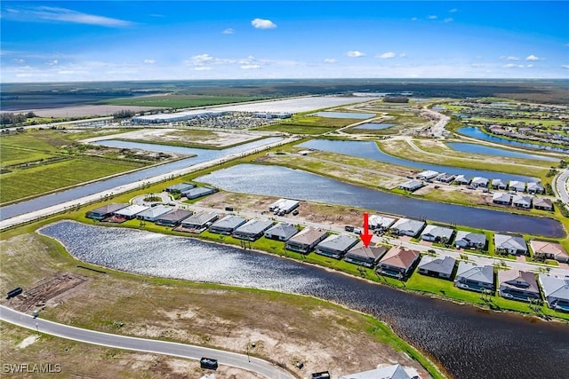 drone / aerial view featuring a water view and a residential view