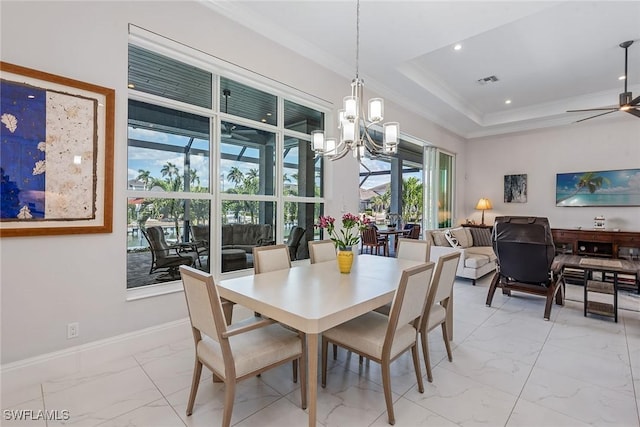 dining space with marble finish floor, ceiling fan with notable chandelier, baseboards, and ornamental molding