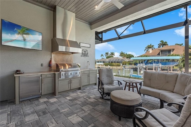 view of patio featuring area for grilling, a sink, ceiling fan, grilling area, and a lanai