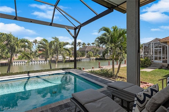 outdoor pool with glass enclosure and a water view