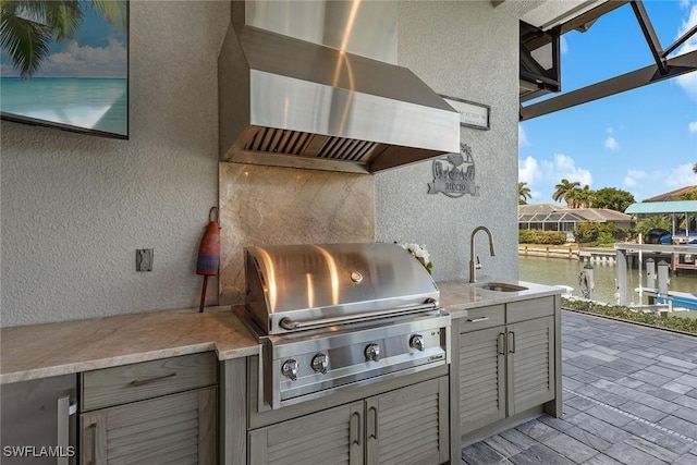 view of patio featuring a sink, grilling area, a water view, and area for grilling