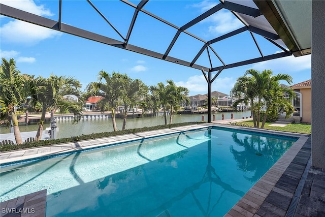 pool with a lanai and a water view