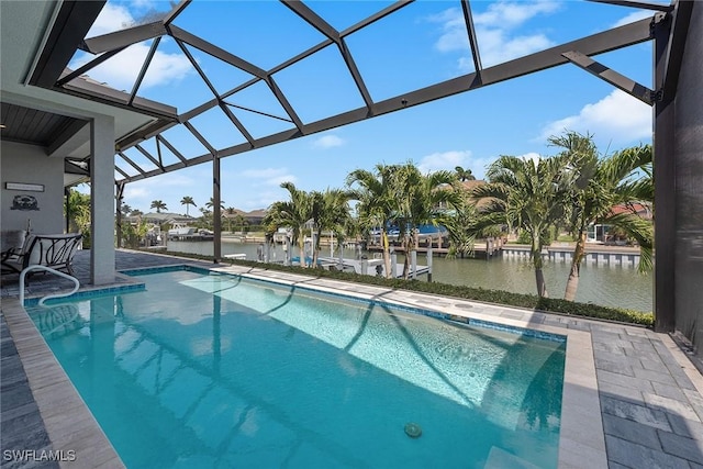 pool with glass enclosure, a water view, and a patio area