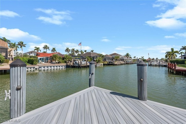 dock area featuring a residential view and a water view