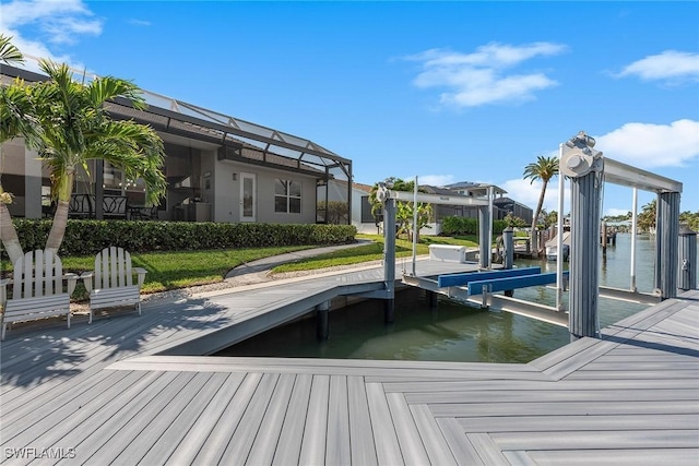 view of dock featuring glass enclosure, a water view, and boat lift