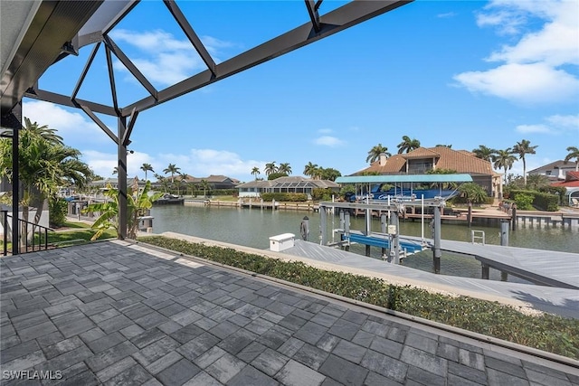 exterior space with glass enclosure, a dock, a water view, and boat lift