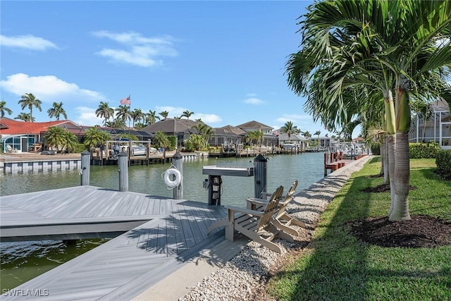 view of dock featuring a residential view and a water view