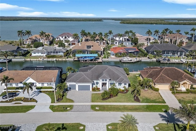 drone / aerial view featuring a residential view and a water view