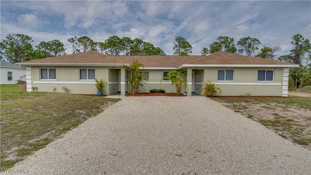 ranch-style home with stucco siding and driveway