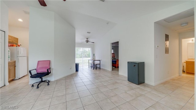 living area with baseboards, lofted ceiling, light tile patterned floors, electric panel, and a ceiling fan