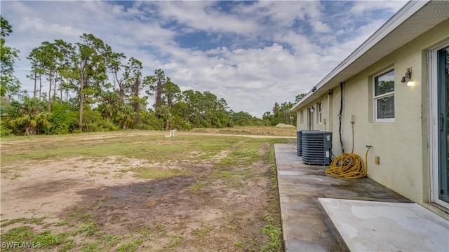 view of yard with a patio area and central AC