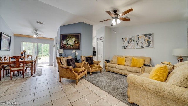 living room with light tile patterned floors, visible vents, lofted ceiling, and ceiling fan