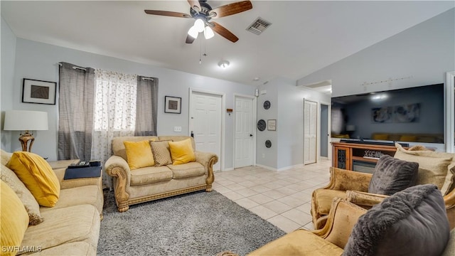 living area with visible vents, a ceiling fan, baseboards, light tile patterned flooring, and lofted ceiling