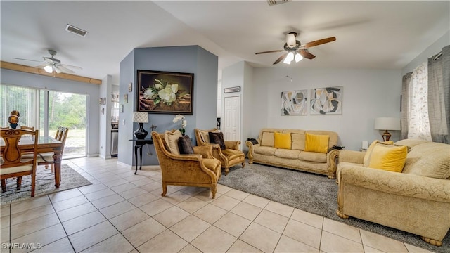 living room with light tile patterned floors, visible vents, lofted ceiling, and ceiling fan