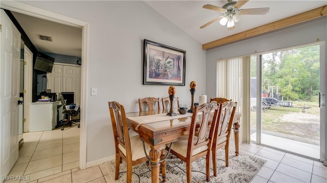 dining area with light tile patterned flooring, visible vents, ceiling fan, and vaulted ceiling