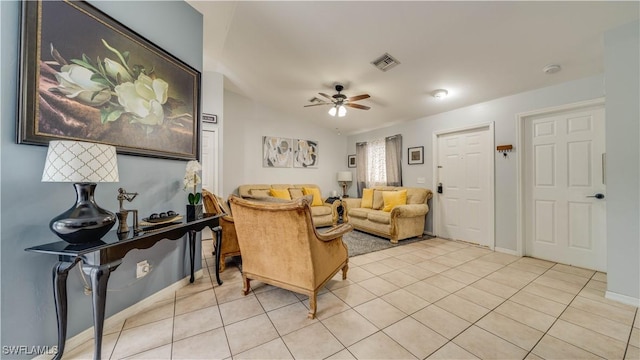 living area with visible vents, baseboards, light tile patterned floors, lofted ceiling, and ceiling fan