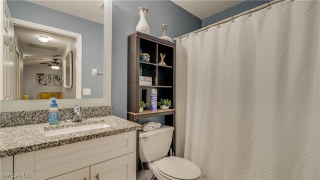 bathroom with vanity, toilet, and a ceiling fan