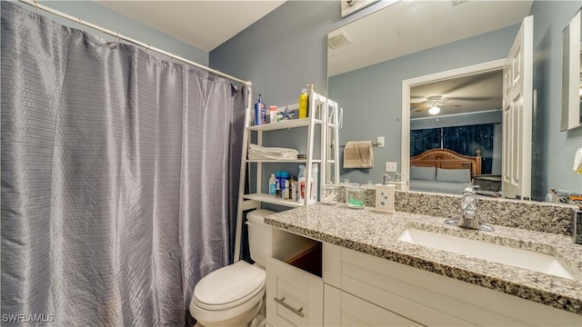 full bath featuring toilet, vanity, and ceiling fan