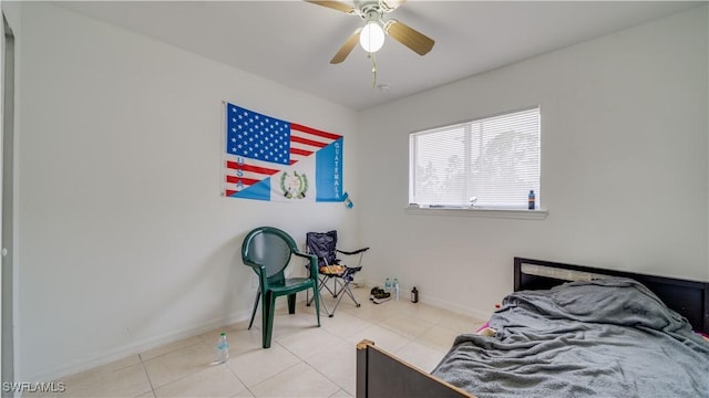 tiled bedroom featuring a ceiling fan and baseboards