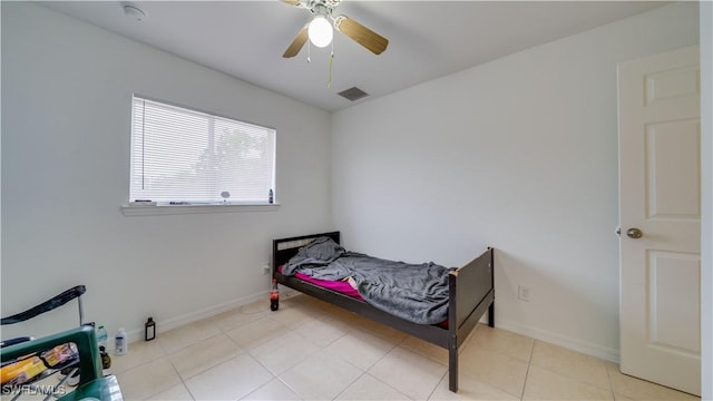 bedroom featuring tile patterned floors, baseboards, visible vents, and ceiling fan