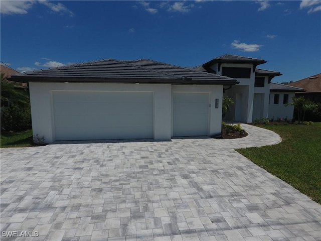 1523 NW 34th Ave, Cape Coral, FL 33993 - prairie-style house featuring decorative driveway, a garage, and stucco siding