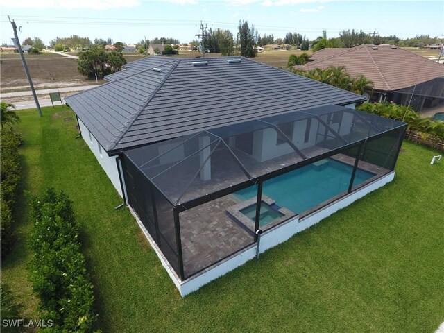 1523 NW 34th Ave, Cape Coral, FL 33993 - view of swimming pool featuring a yard, a pool with connected hot tub, and glass enclosure
