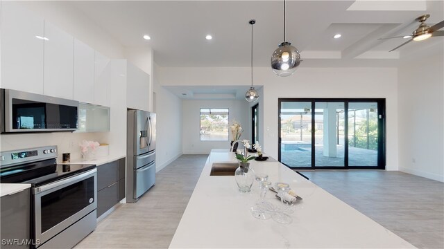1523 NW 34th Ave, Cape Coral, FL 33993 - kitchen featuring appliances with stainless steel finishes, modern cabinets, light countertops, light wood-style flooring, and recessed lighting