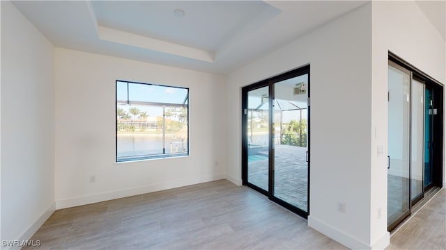 1523 NW 34th Ave, Cape Coral, FL 33993 - empty room featuring a raised ceiling and light wood finished floors