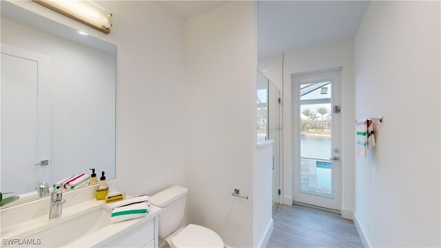 1523 NW 34th Ave, Cape Coral, FL 33993 - bathroom with vanity, wood finished floors, and a shower with door