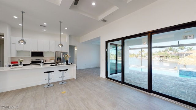 1523 NW 34th Ave, Cape Coral, FL 33993 - kitchen with modern cabinets, stainless steel appliances, white cabinetry, light countertops, and a towering ceiling