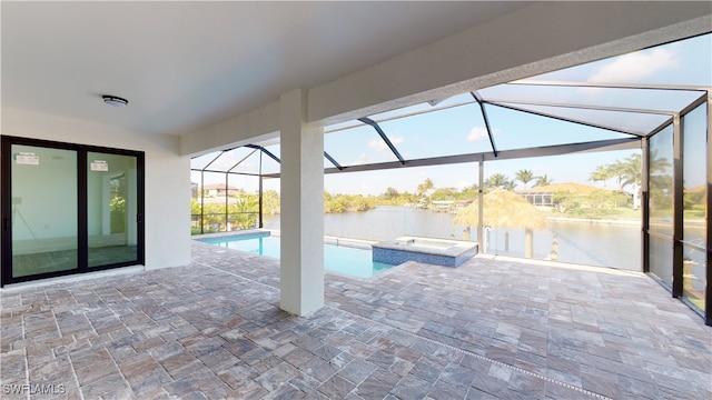 1523 NW 34th Ave, Cape Coral, FL 33993 - view of pool featuring a water view, a patio, a pool with connected hot tub, and a lanai