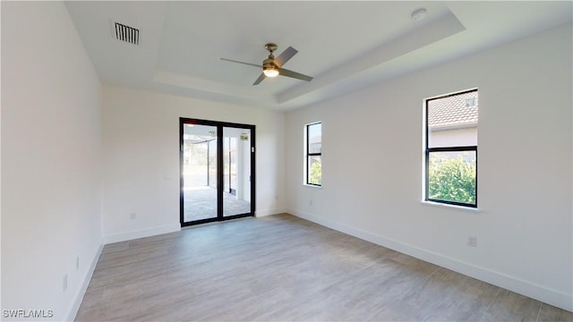 1523 NW 34th Ave, Cape Coral, FL 33993 - spare room with a raised ceiling, ceiling fan, light wood-style floors, and a smoke detector