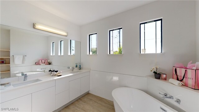 1523 NW 34th Ave, Cape Coral, FL 33993 - full bath with healthy amount of natural light, a soaking tub, and double vanity