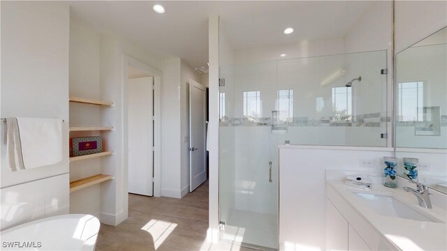 1523 NW 34th Ave, Cape Coral, FL 33993 - bathroom with a stall shower, a freestanding tub, vanity, wood finished floors, and recessed lighting