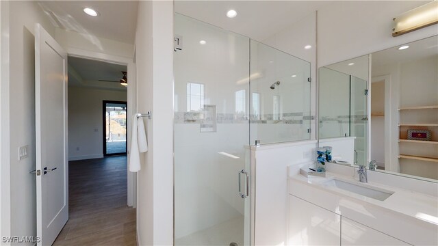 1523 NW 34th Ave, Cape Coral, FL 33993 - full bath with a stall shower, vanity, ceiling fan, wood finished floors, and recessed lighting