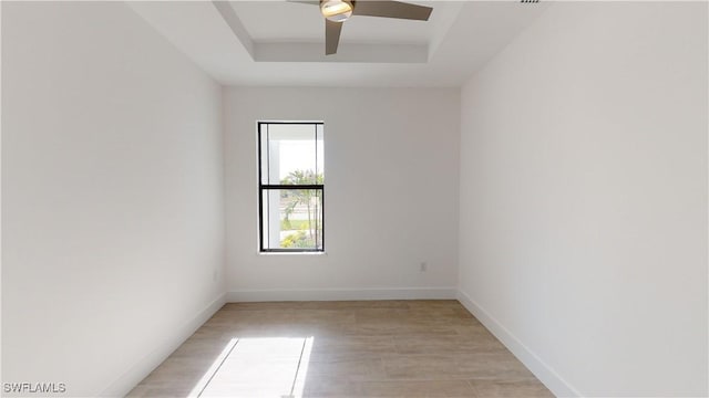 1523 NW 34th Ave, Cape Coral, FL 33993 - unfurnished room featuring a tray ceiling, light wood-style floors, and ceiling fan