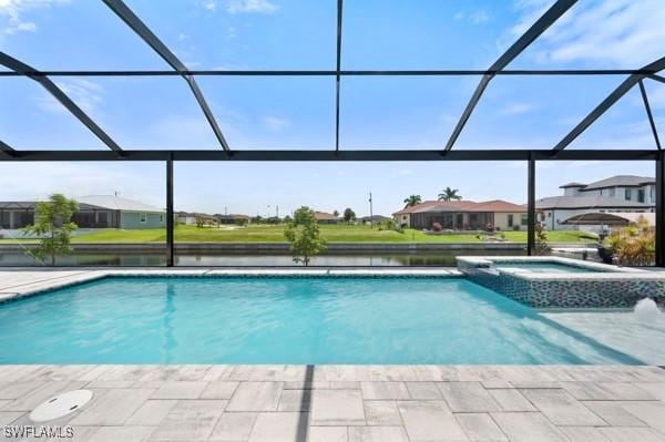 1523 NW 34th Ave, Cape Coral, FL 33993 - view of pool featuring glass enclosure, a pool with connected hot tub, and a residential view