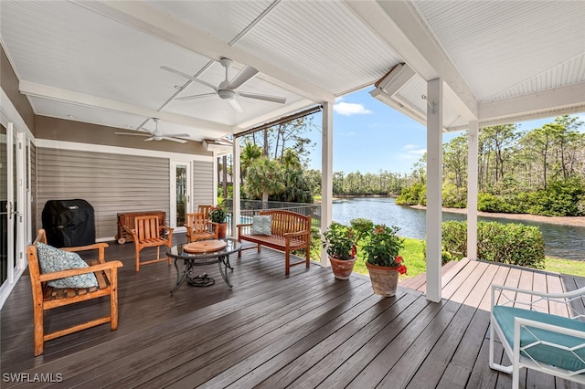 deck with a water view, ceiling fan, and grilling area