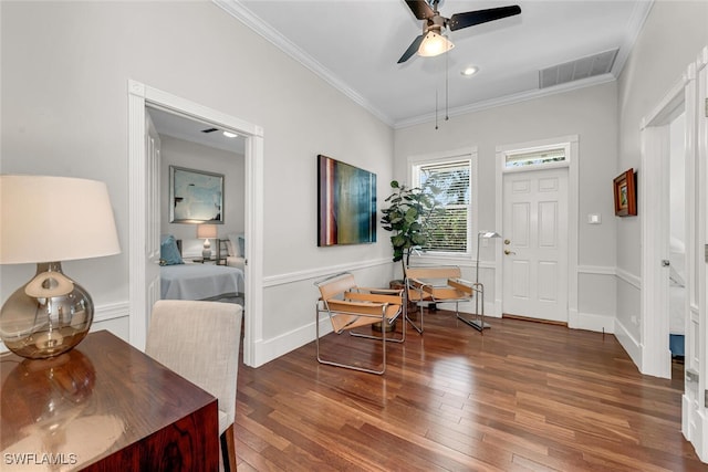 foyer entrance with wood-type flooring, visible vents, ceiling fan, and ornamental molding