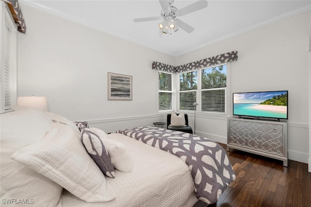 bedroom with ornamental molding, baseboards, ceiling fan, and hardwood / wood-style floors