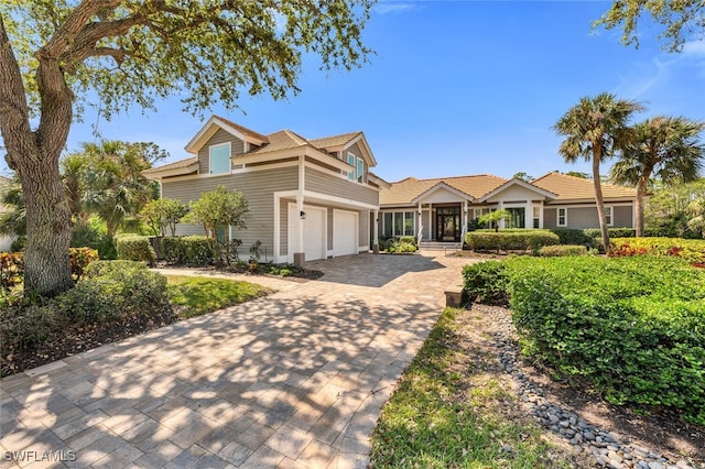 view of front of house with decorative driveway and an attached garage