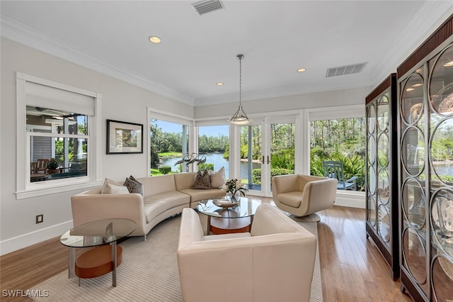 sunroom / solarium featuring a water view and visible vents