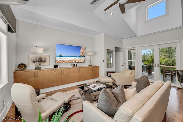 living room featuring french doors, visible vents, ceiling fan, wood finished floors, and high vaulted ceiling