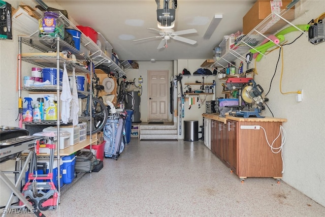 garage featuring a workshop area, a ceiling fan, and a garage door opener